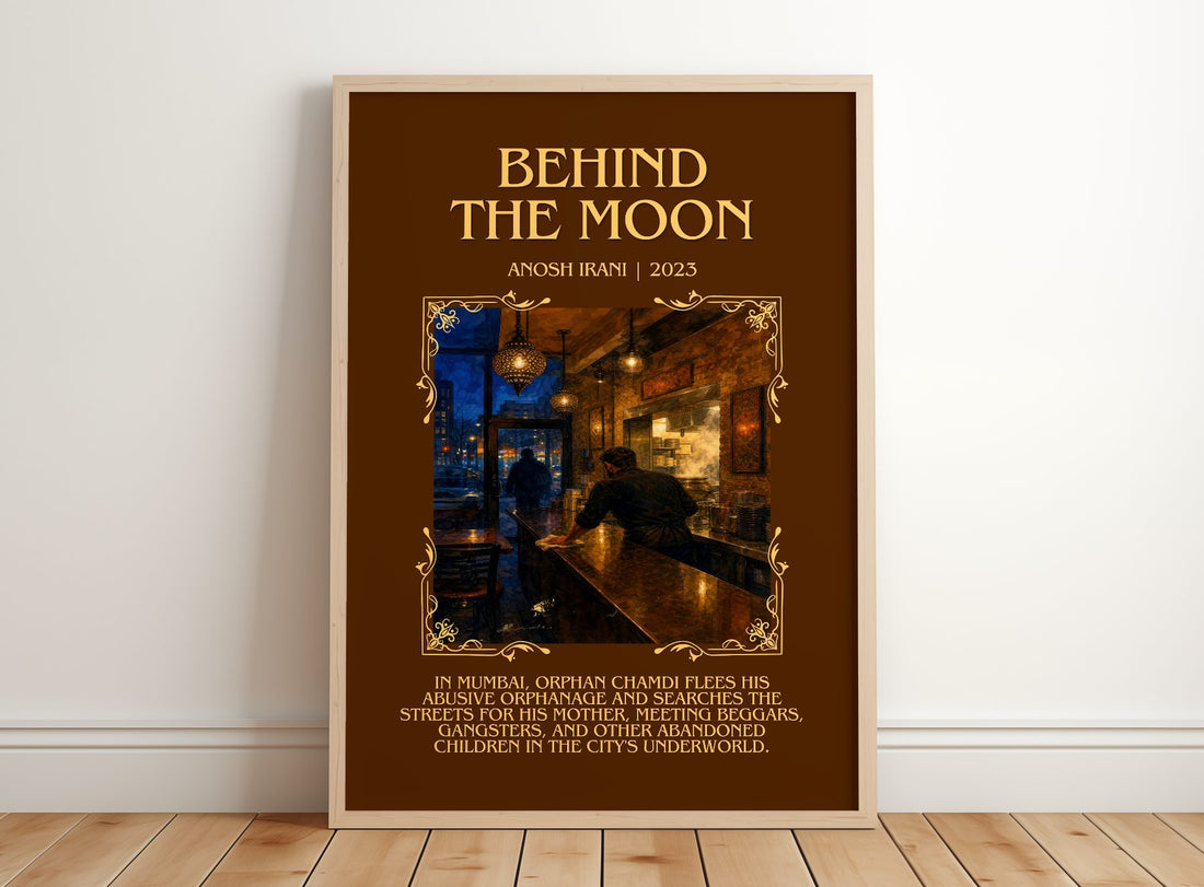 Behind The Moon Minimalist Book Poster by Anosh Irani – framed print leaning on a wooden floor