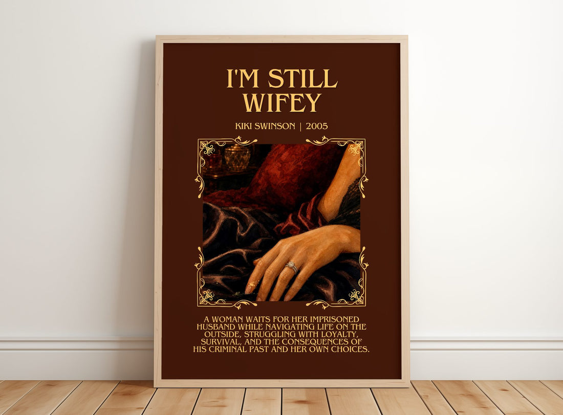 I'm Still Wifey Minimalist Book Poster by Kiki Swinson – framed print leaning on a wooden floor