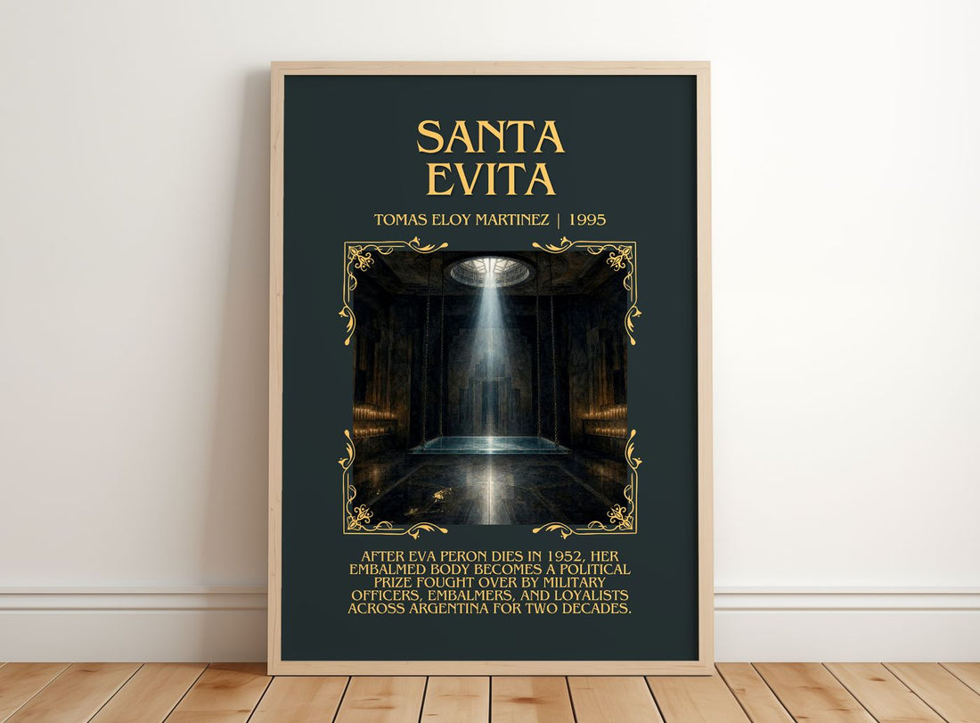 Santa Evita Minimalist Book Poster by Tomás Eloy Martínez – framed print leaning on a wooden floor