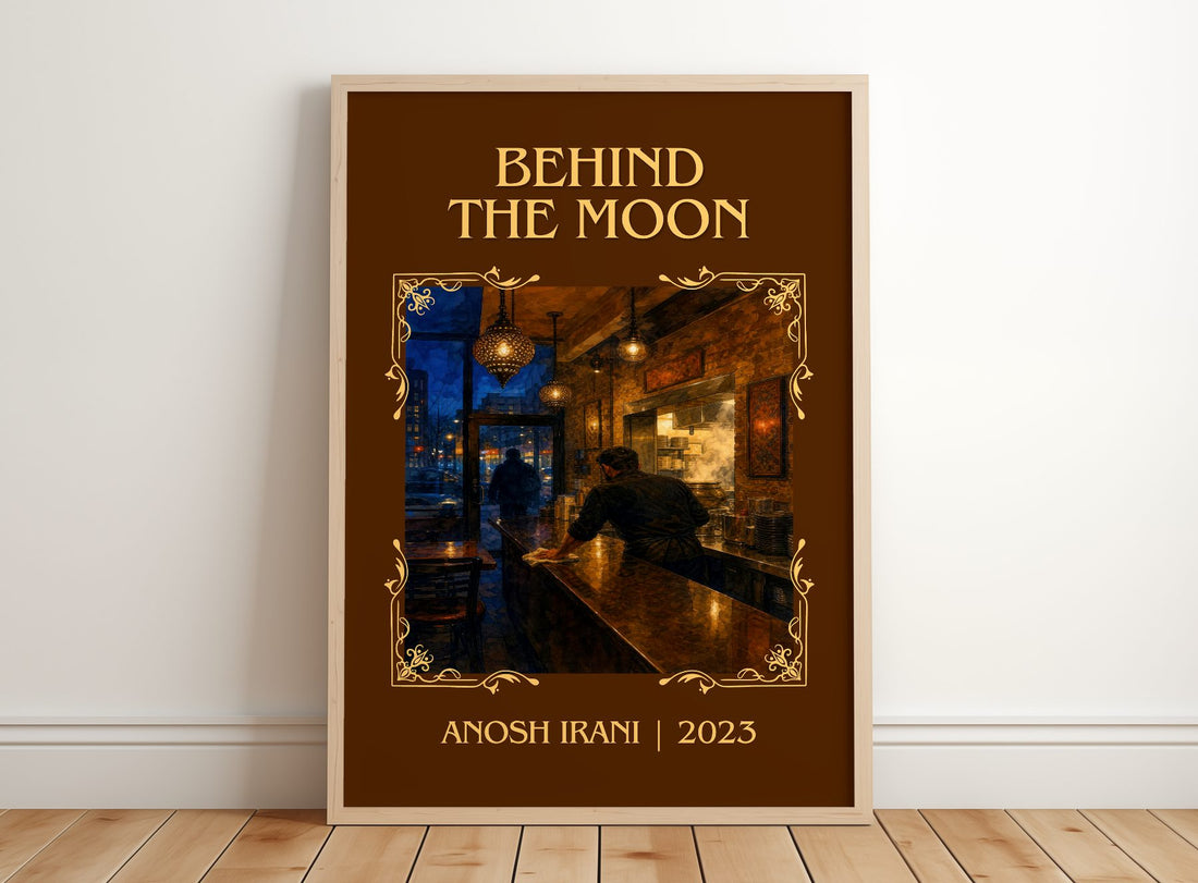 Behind The Moon Classic Book Art Print by Anosh Irani – framed print leaning on a wooden floor
