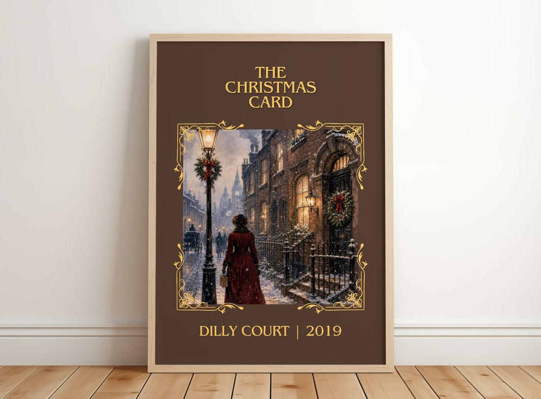 The Christmas Card Classic Book Art Print by Dilly Court – framed print leaning on a wooden floor