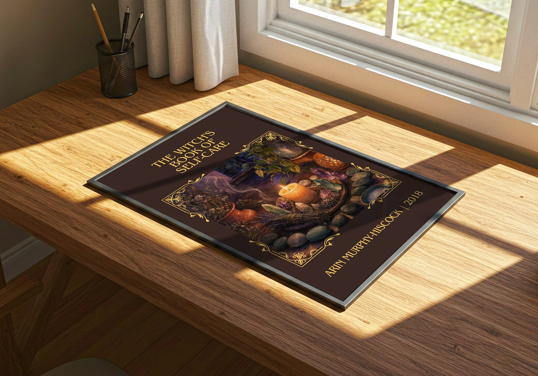 Witch's Book of Self-Care Classic Book Art Print by A. Murphy-Hiscock – print on a sunlit desk