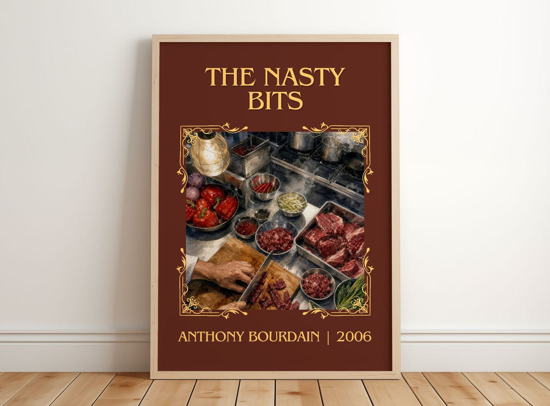 The Nasty Bits Classic Book Art Print by Anthony Bourdain – framed print leaning on a wooden floor