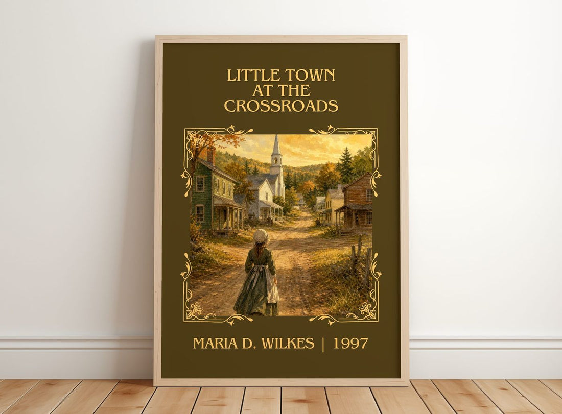 Little Town at the Crossroads Classic Book Art Print by M. Wilkes – framed print leaning on a wooden floor