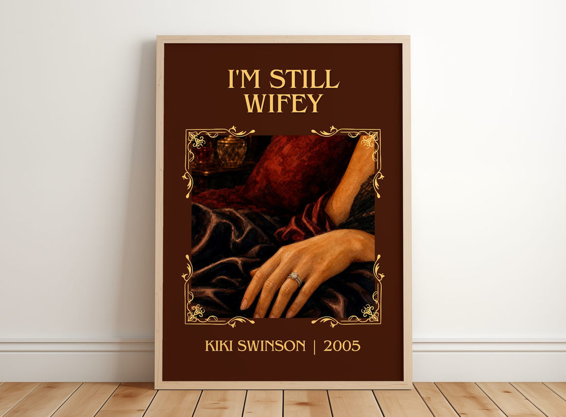 I'm Still Wifey Classic Book Art Print by Kiki Swinson – framed print leaning on a wooden floor