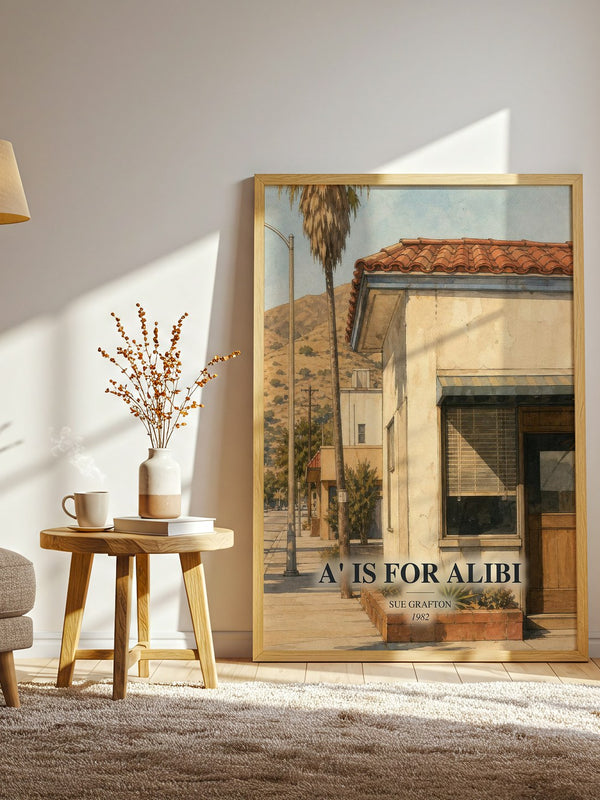 A' Is for Alibi watercolour print in frame leaning in hallway – mystery wall art