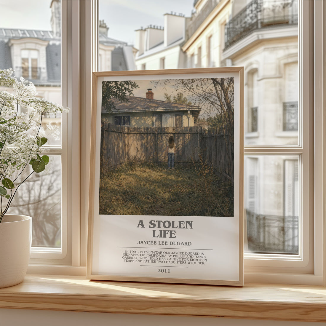 A Stolen Life Bookish Wall Art by Jaycee Lee Dugard – framed print by a bright window