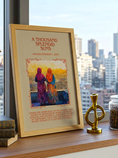 A Thousand Splendid Suns Minimalist Book Poster by Khaled Hosseini – framed print on a city-view windowsill