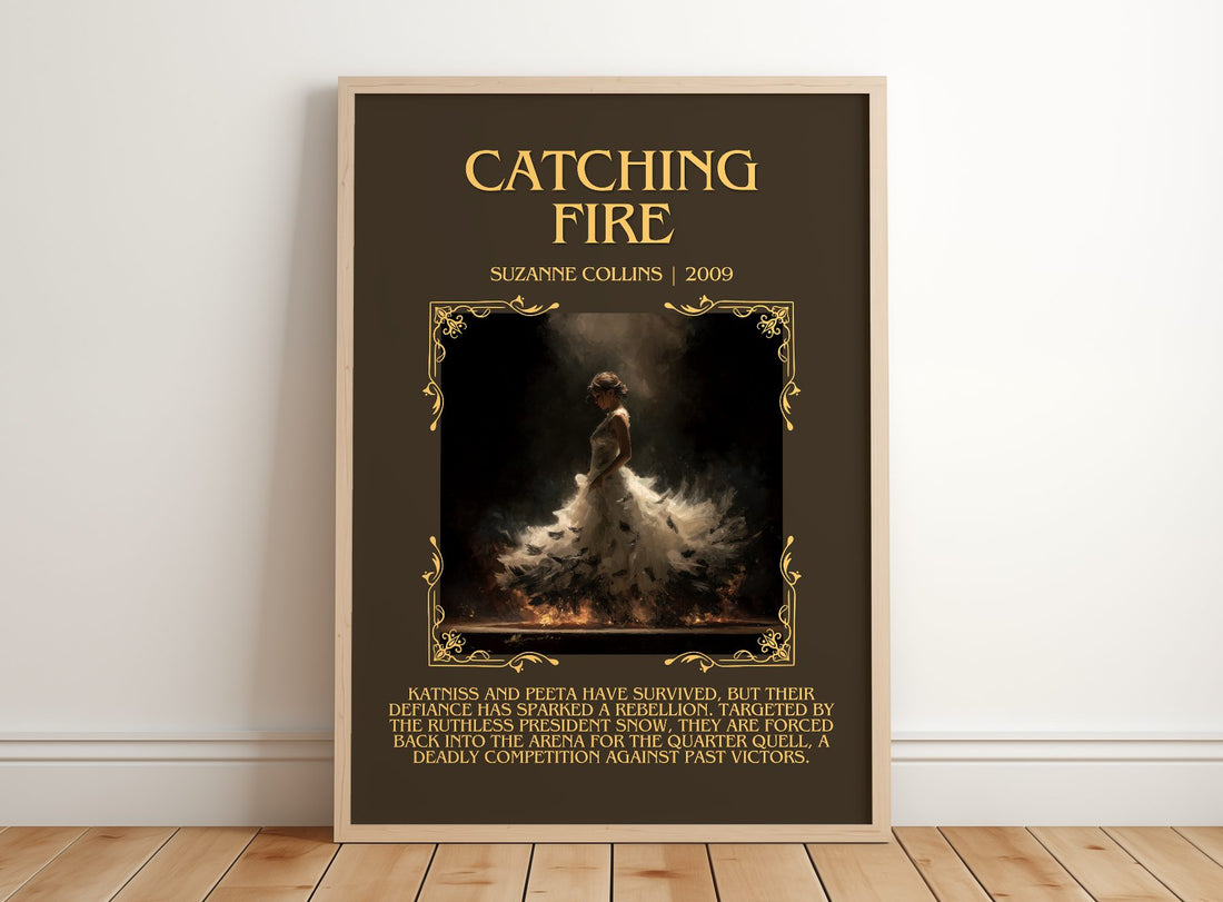 Catching Fire Minimalist Book Poster by Suzanne Collins – framed print leaning on a wooden floor