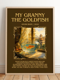 My Granny The Goldfish Minimalist Book Poster by Anosh Irani – framed print leaning on a wooden floor