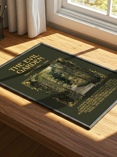 The Evil Garden Minimalist Book Poster by Edward Gorey – print on a sunlit desk