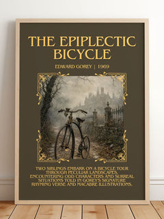 The Epiplectic Bicycle Minimalist Book Poster by Edward Gorey – framed print leaning on a wooden floor