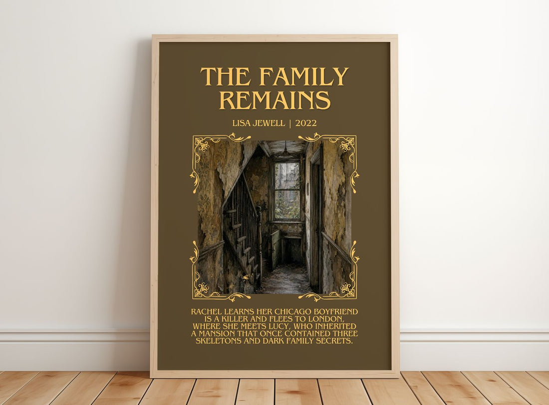 The Family Remains Minimalist Book Poster by Lisa Jewell – framed print leaning on a wooden floor