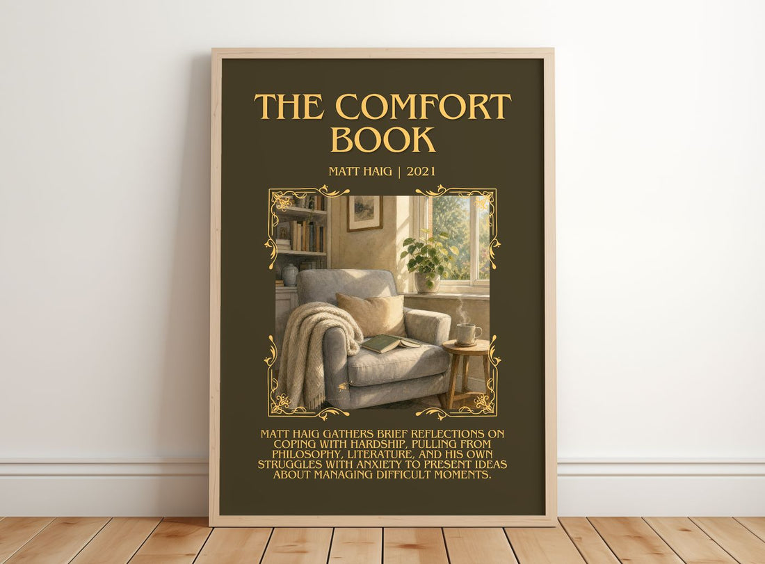 The Comfort Book Minimalist Book Poster by Matt Haig – framed print leaning on a wooden floor