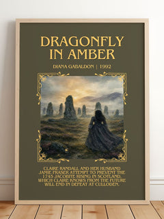 Dragonfly in Amber Minimalist Book Poster by Diana Gabaldon – framed print leaning on a wooden floor
