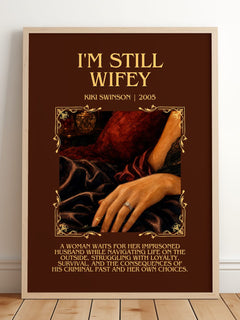 I'm Still Wifey Minimalist Book Poster by Kiki Swinson – framed print leaning on a wooden floor