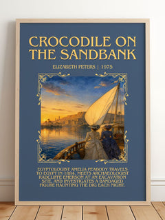 Crocodile on the sandbank Minimalist Book Poster by Elizabeth Peters – framed print leaning on a wooden floor