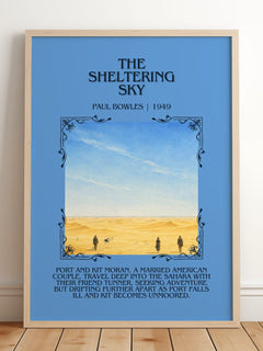 The Sheltering Sky Minimalist Book Poster by Paul Bowles – framed print leaning on a wooden floor