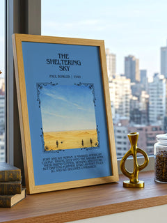 The Sheltering Sky Minimalist Book Poster by Paul Bowles – framed print on a city-view windowsill