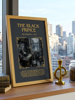 The Black Prince Minimalist Book Poster by Iris Murdoch – framed print on a city-view windowsill
