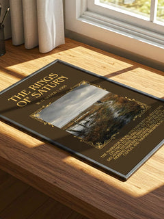 The Rings of Saturn Minimalist Book Poster by W. G. Sebald – print on a sunlit desk