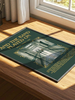 And the Band Played On Minimalist Book Poster by Randy Shilts – print on a sunlit desk