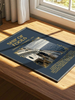 Ship Of Fools Minimalist Book Poster by Katherine Anne Porter – print on a sunlit desk