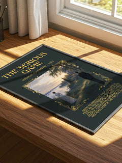 The Serious Game Minimalist Book Poster by Hjalmar Soderberg – print on a sunlit desk