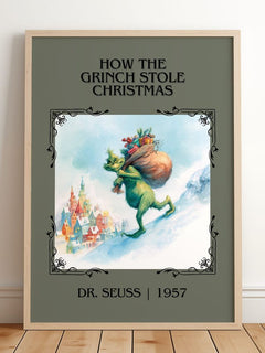 How The Grinch Stole Christmas Classic Book Art Print by Dr. Seuss – framed print leaning on a wooden floor