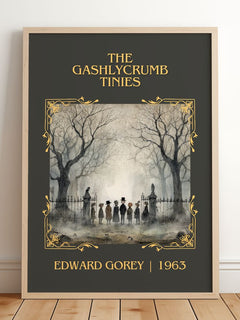 The Gashlycrumb Tinies Classic Book Art Print by Edward Gorey – framed print leaning on a wooden floor