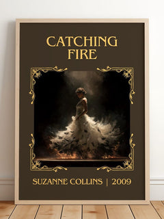 Catching Fire Classic Book Art Print by Suzanne Collins – framed print leaning on a wooden floor