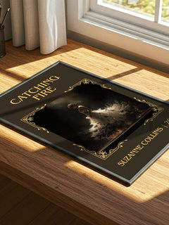 Catching Fire Classic Book Art Print by Suzanne Collins – print on a sunlit desk