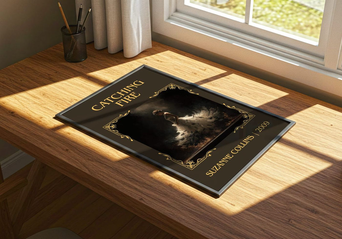 Catching Fire Classic Book Art Print by Suzanne Collins – print on a sunlit desk