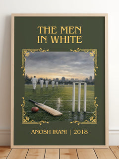 The Men In White Classic Book Art Print by Anosh Irani – framed print leaning on a wooden floor