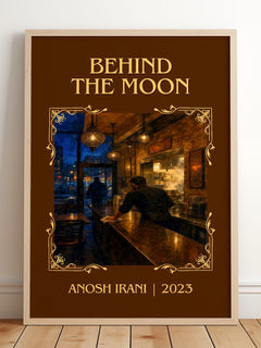Behind The Moon Classic Book Art Print by Anosh Irani – framed print leaning on a wooden floor
