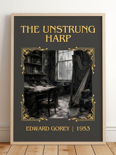 The Unstrung Harp Classic Book Art Print by Edward Gorey – framed print leaning on a wooden floor