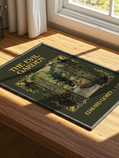 The Evil Garden Classic Book Art Print by Edward Gorey – print on a sunlit desk