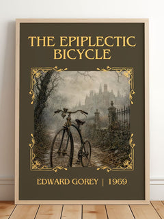 The Epiplectic Bicycle Classic Book Art Print by Edward Gorey – framed print leaning on a wooden floor