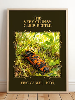 The Very Clumsy Click Beetle Classic Book Art Print by Eric Carle – framed print leaning on a wooden floor
