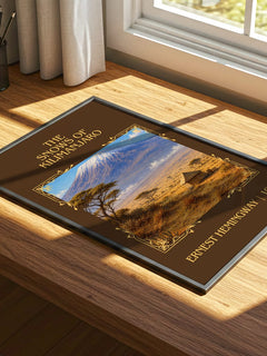 The Snows Of Kilimanjaro Classic Book Art Print by Ernest Hemingway – print on a sunlit desk