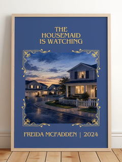The Housemaid Is Watching Classic Book Art Print by Freida Mcfadden – framed print leaning on a wooden floor