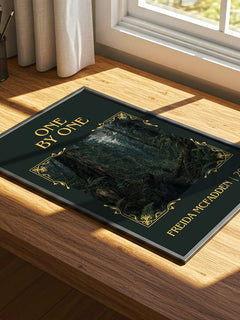 One By One Classic Book Art Print by Freida Mcfadden – print on a sunlit desk
