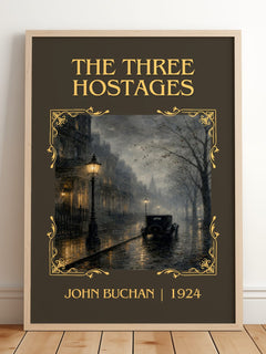 The Three Hostages Classic Book Art Print by John Buchan – framed print leaning on a wooden floor