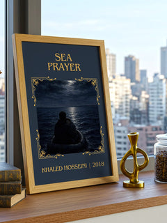 Sea Prayer Classic Book Art Print by Khaled Hosseini – framed print on a city-view windowsill