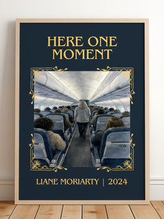 Here One Moment Classic Book Art Print by Liane Moriarty – framed print leaning on a wooden floor