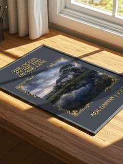 The Ocean At The End Of The Lane Classic Book Art Print by Neil Gaiman – print on a sunlit desk