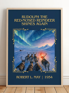Rudolph The Red-Nosed Reindeer Shines Again Classic Book Art Print by Robert L. May – framed print leaning on a wooden floor