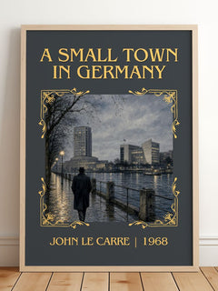 A Small Town in Germany Classic Book Art Print by John le Carré – framed print leaning on a wooden floor