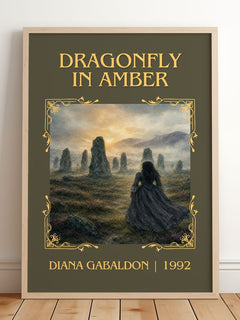 Dragonfly in Amber Classic Book Art Print by Diana Gabaldon – framed print leaning on a wooden floor