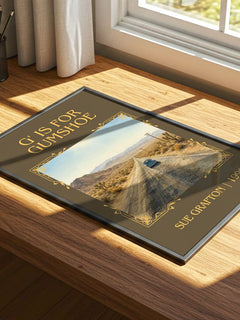 G' Is for Gumshoe Classic Book Art Print by Sue Grafton – print on a sunlit desk